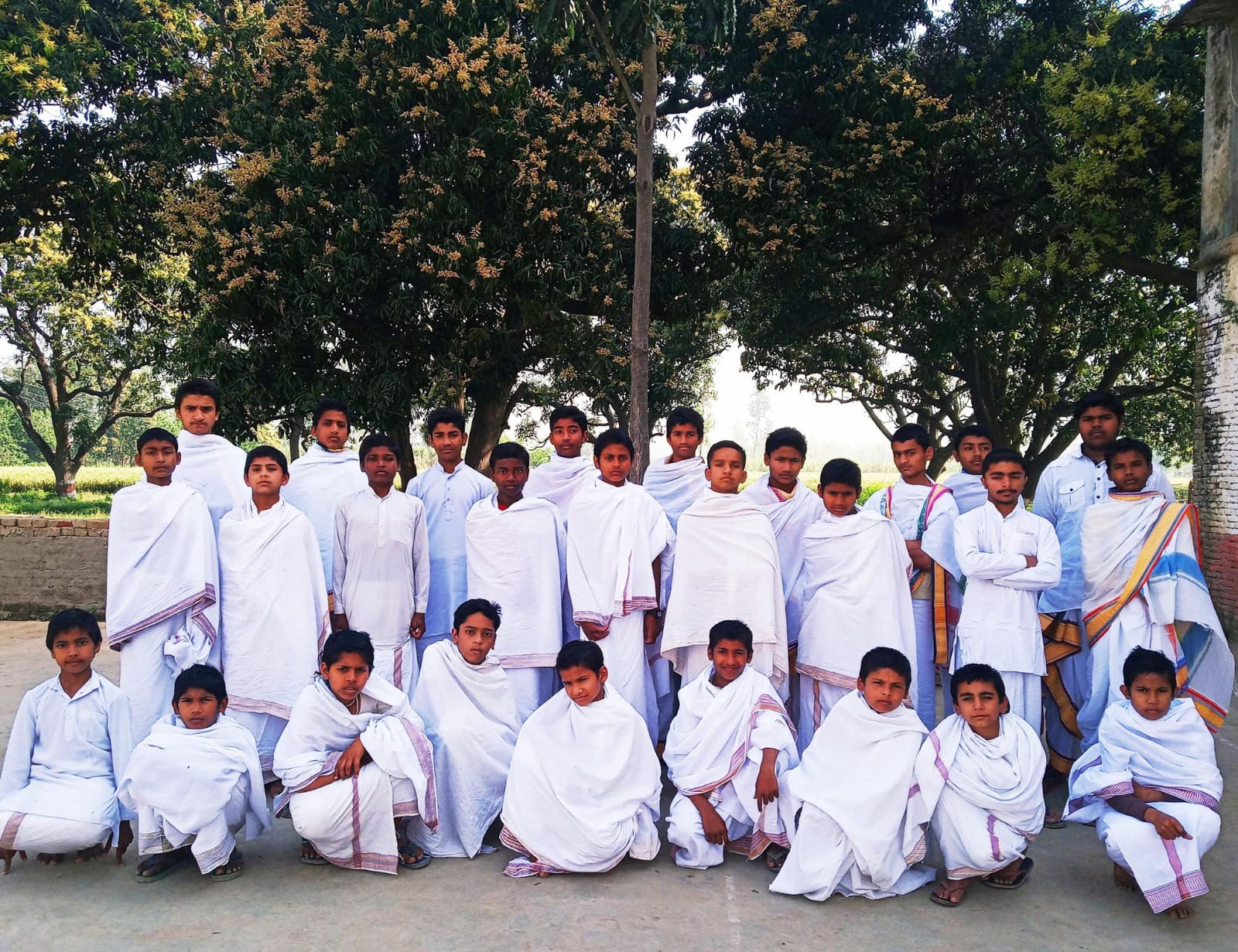 Vedic Gurukul students gathered beneath sacred trees